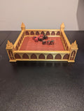 Gothic Cathedral Dice Tray in gold and crimson, front view with dice and sword-emblem corner towers